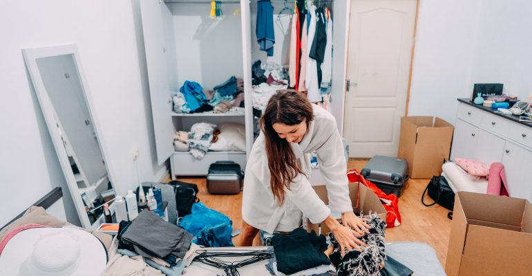 Nice-looking lady inside modern apartment room prepare to trip, around the mess